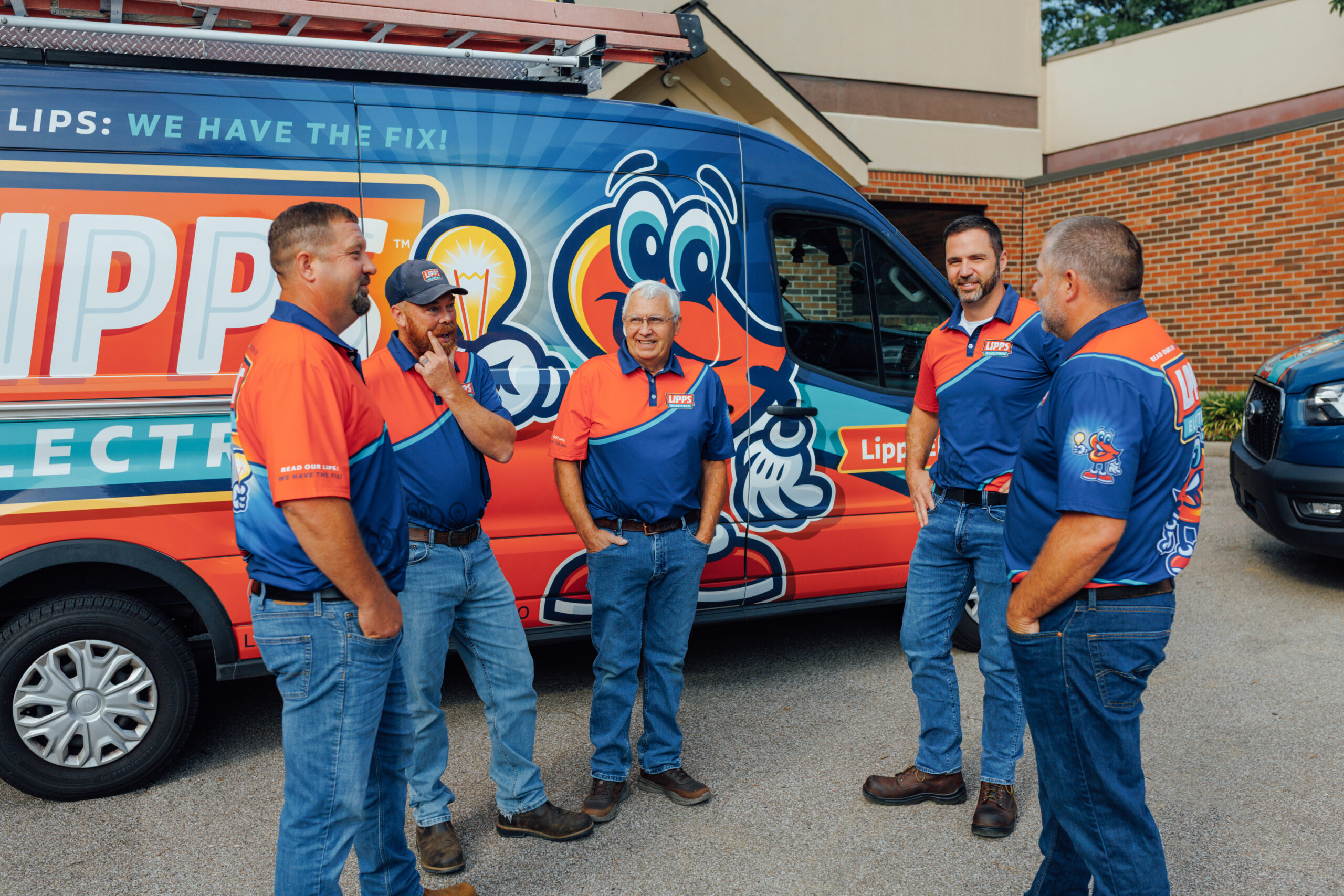 The Lipps Electric family leadership team standing beside a branded service van in Greater Cincinnati.