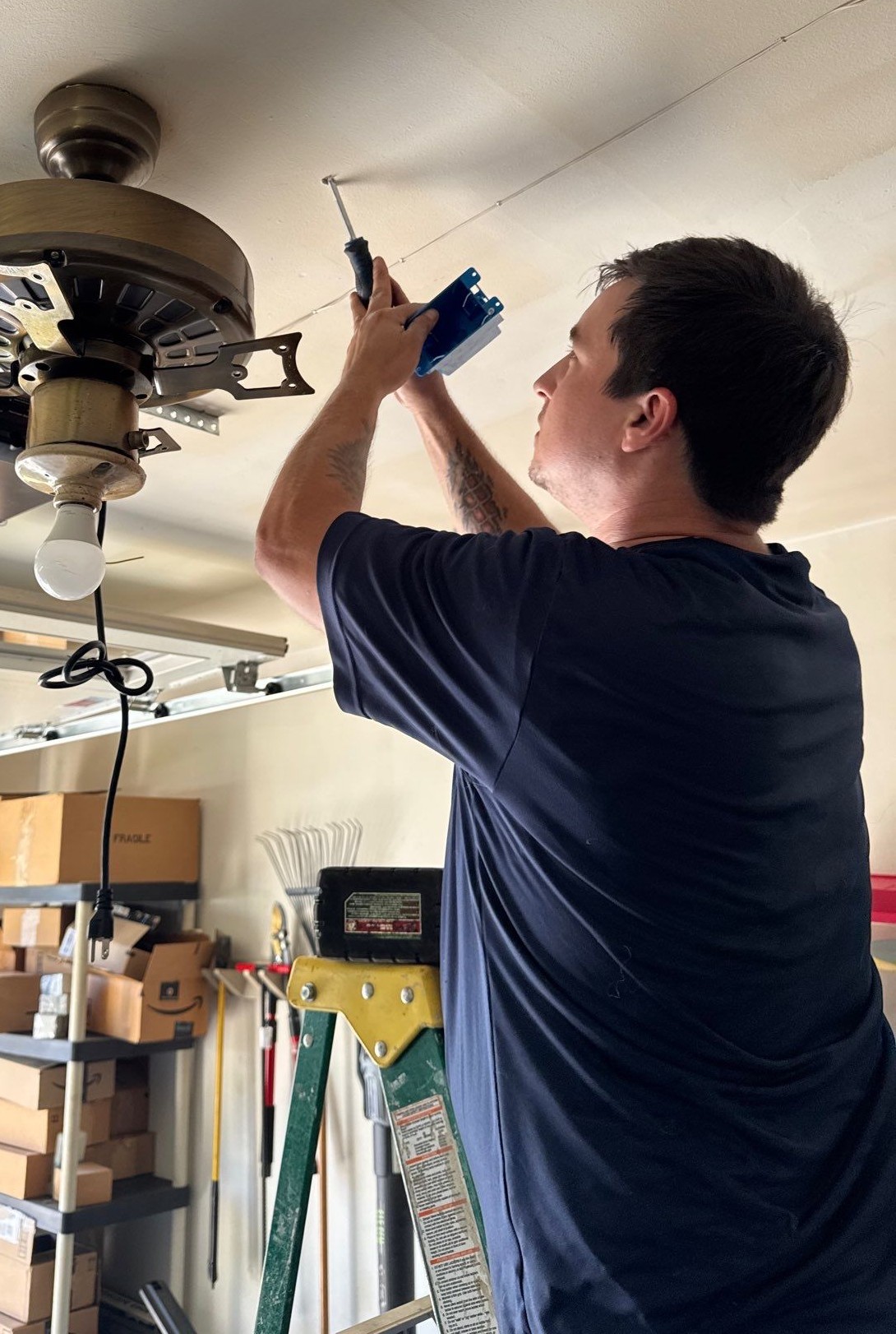 Electrician installing a new electrical outlet and wiring in a Greater Cincinnati home